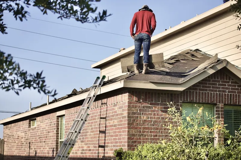 Professional roofer working on a residential roof in Calumet